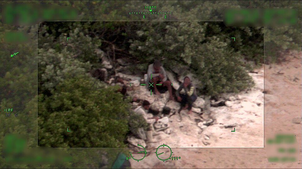 A Coast Guard Air Station Miami aircrew photographs Cuban migrants stranded after an unlawful maritime migration attempt near Anguilla Cay, Bahamas. The Coast Guard Cutter Paul Clark's crew arrived on scene and rescued the people before transferring them to the Bahamas. (U.S. Coast Guard photo)
