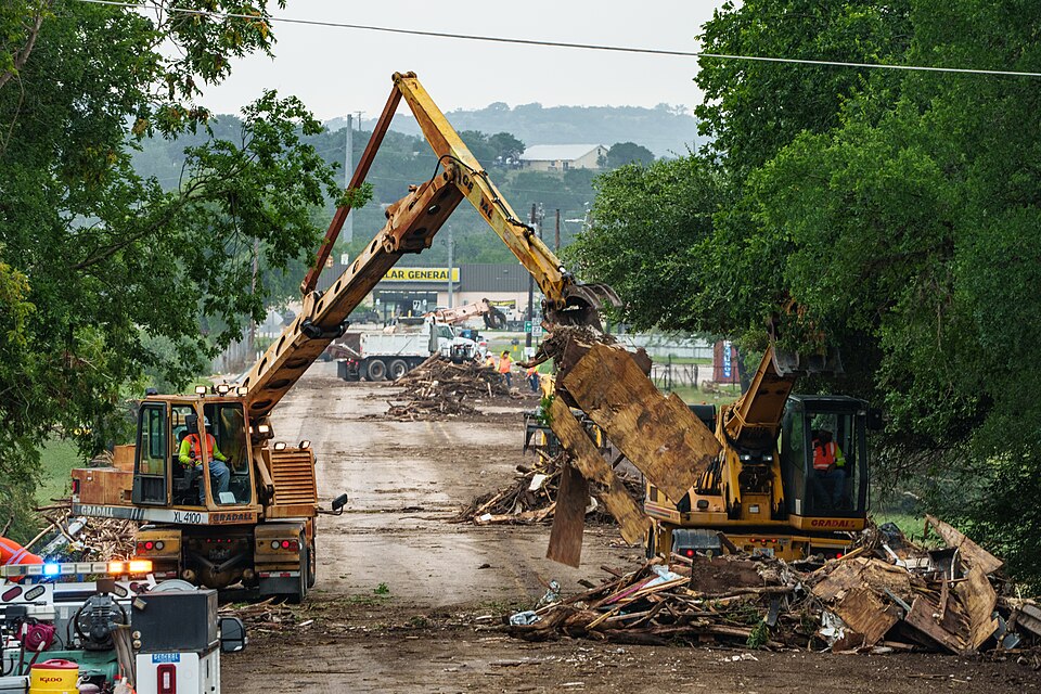 Crews remove debris from the San Antonio St, Bridge, which was inundated with flood water from the Guadalupe River, in Center Point, Texas, on July 5, 2025. Debris and storm water flow from the July 4, 2025 rainstorm closed the bridge until cleared . This storm caused the river level to rise approxi