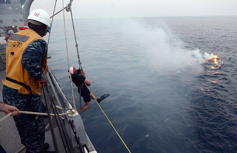 ARABIAN GULF (June 29, 2013) A search and rescue swimmer is lowered over the side of guided-missile destroyer USS Higgins (DDG 76) during a man overboard drill. Higgins is deployed to the U.S. 5th Fleet area of responsibility promoting maritime security operations, theater security cooperation effor