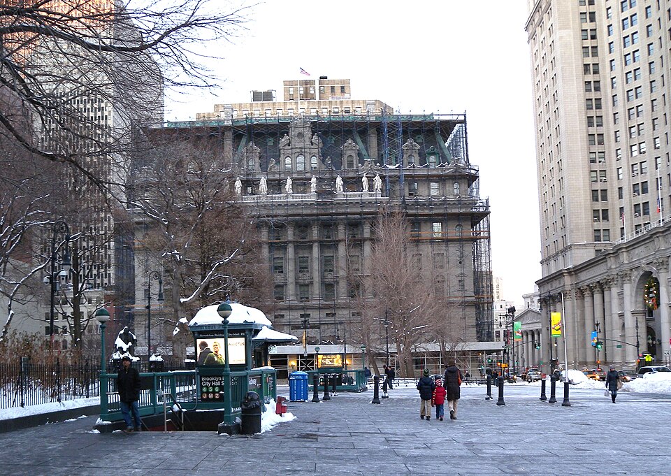 Looking north from Park Row at IRT stair and Chambers Street near dusk of a sunny day.