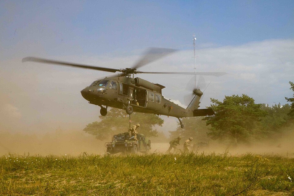 U.S. Soldiers assigned to B Company, 43rd Assault Helicopter Battalion, 3rd Cavalry Regiment, 3rd Infantry Division, hover their UH-60M Black Hawk helicopter above Soldiers assigned to Dog Company, 1st Battalion, 503rd Infantry Regiment, 173rd Infantry Brigade Combat Team (Airborne), 4th Infantry Di