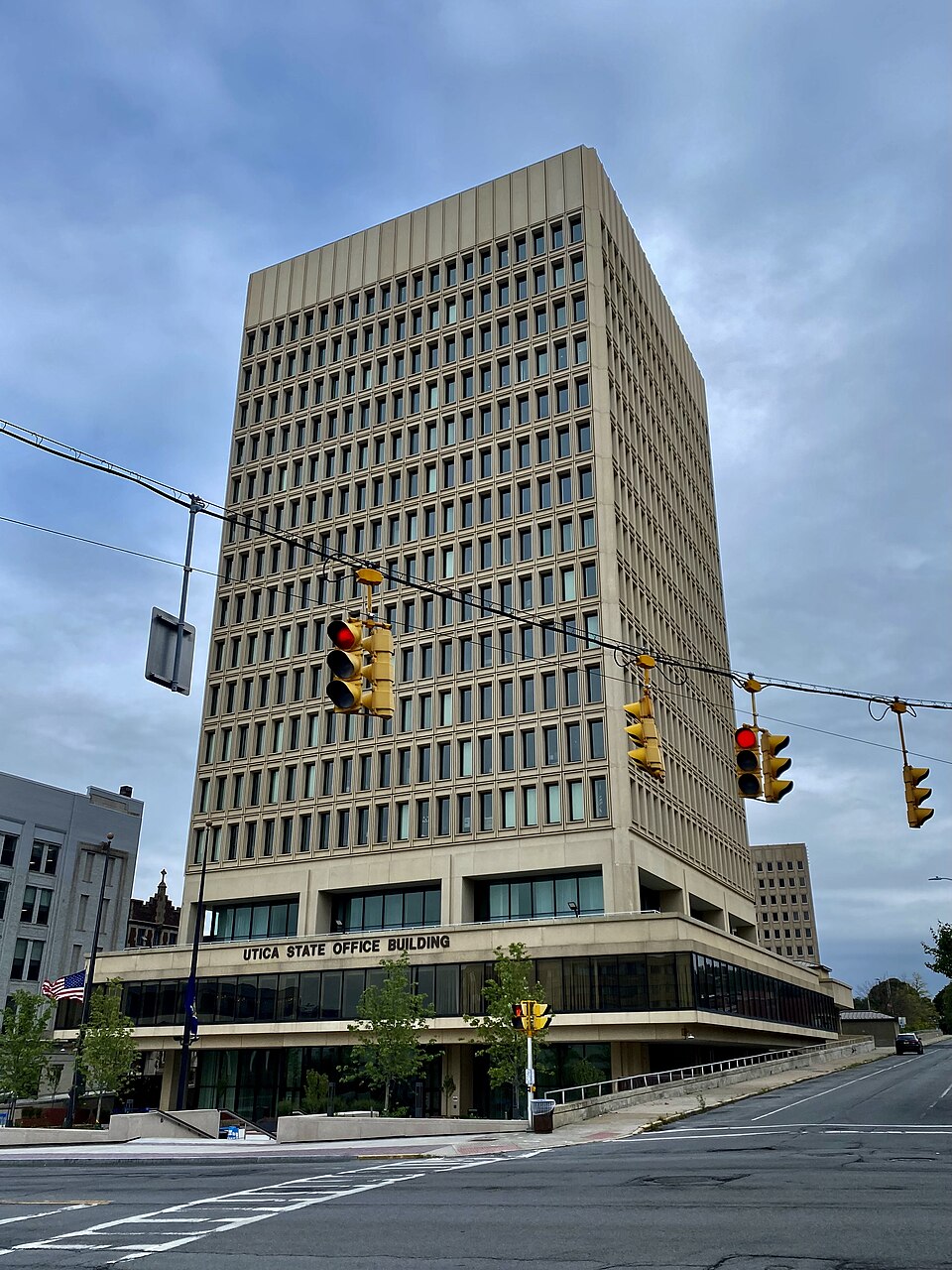 The Utica State Office Building, 207 Genesee Street at Blandina Street, as seen on an August 2021 afternoon. With a simple, angular design of regular rows and columns of narrow windows deeply recessed into a smooth-textured façade of concrete panels, this 17-story building, the tallest in the city, 