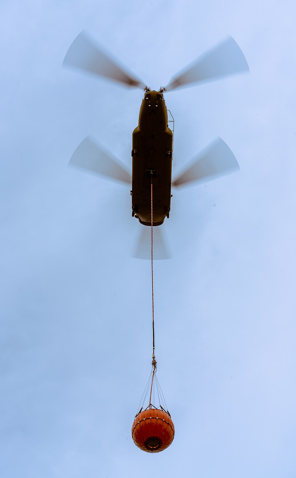 U.S. Army aircrews assigned to Bravo Company, 1st Battalion, 214th Aviation Regiment, part of 12th Combat Aviation Brigade, lower a CH-47 Chinook helicopter with an underslung water bucket to train on aerial firefighting operations, at Grafenwoehr Training Area’s Schlatterweiher Lake, Germany, Aug. 