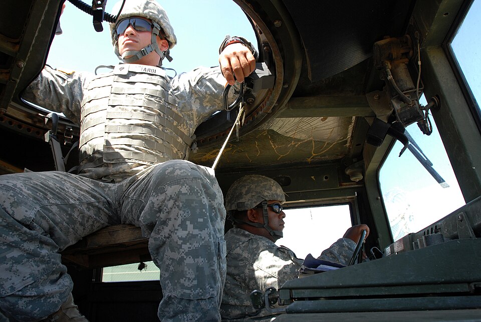 Army Spc. Kevin Tardi and Army Spc. Fernando Soto, military policemen from Joint Task Force Guantanamo's 480th Military Police Company, patrol the perimeter of JTF Guantanamo, Oct. 7.  The 480th MP Company, part of the 525th Military Police Battalion, provides external security to the JTF and suppor