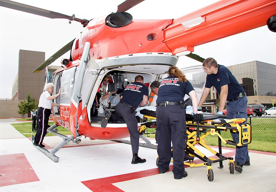 Beaumont, TX, September 25, 2005 -- EMT personnel help load a patient onto a medevac helipoter for transport to Houston.  Judi Mayne, a paramedic, watches from the door.  D-MAT units, a part of FEMA, augment the Memorial Hermann Emergency Room operation.   Photo by Ed Edahl/FEMA