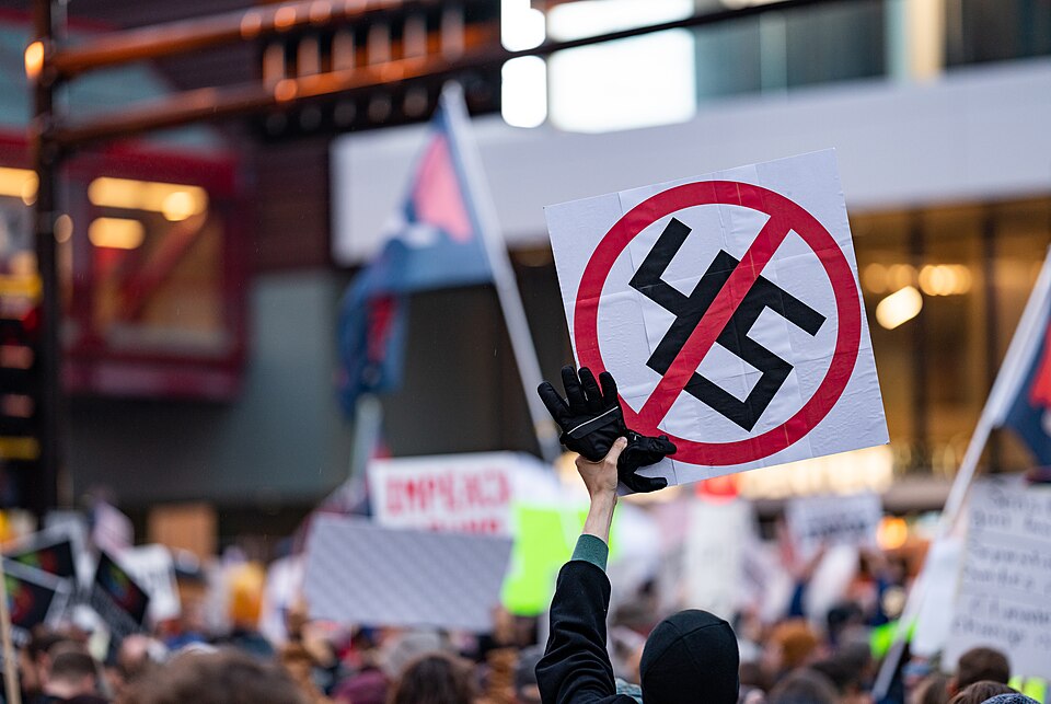 A protester holds a sign with '45' crossed out, which has the visual appearance of a Nazi swastika crossed out, outside a Donald Trump for President campaign rally at the Target Center arena in downtown Minneapolis, Minnesota, on October 10, 2019.