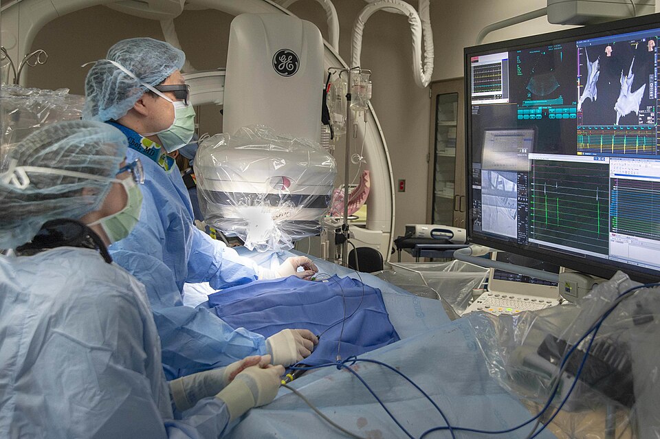 210219-N-LW757-1085
SAN DIEGO (Feb. 19, 2021) Lt. Emily Calhoun, a medical resident (left), and Lt. Cmrd. Andrew Choi, a cardiologist (right), both assigned to Naval Medical Center San Diego (NMCSD), conduct an electrophysiology study in the hospital's cardiac catheterization laboratory Feb. 19. Ele