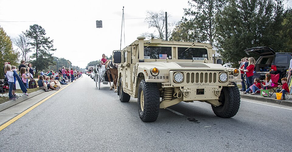 A High-Mobility Multipurpose Wheeled Vehicle driven by Soldiers assigned to the 26th Brigade Support Battalion, 2nd Armored Brigade Combat Team, 3rd Infantry Division, is the last element of the formation in the 18th Annual Hometown Christmas Parade in Richmond Hill, Ga., Dec. 7, 2013.