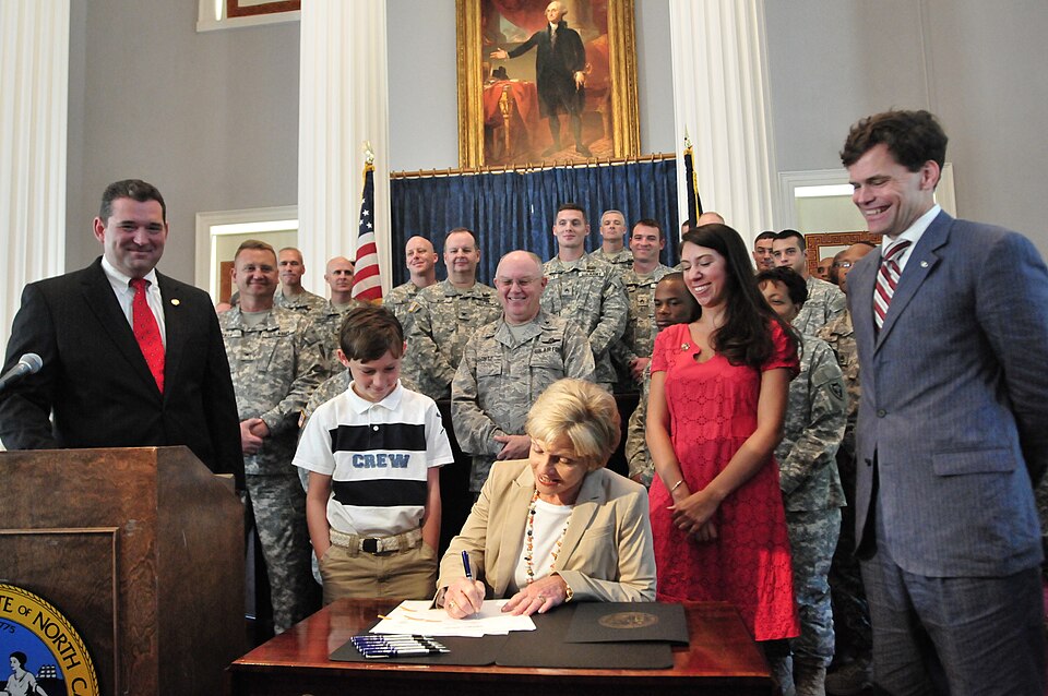 Governor of North Carolina Beverly Purdue signing four military-related bills into law at the North Carolina State Capitol Building. The legislation included reforms to simplify laws applying to military servicemen and concerning laws involving military servicemen absentee voting, also laws mandatin