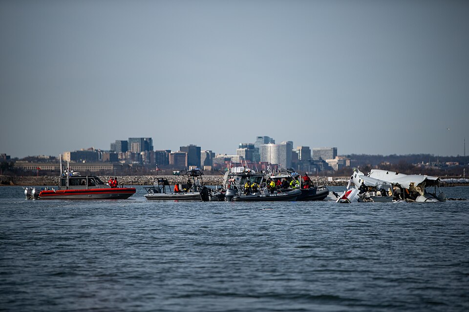 Response boat crews from Coast Guard stations Washington, Curtis Bay, Annapolis, Oxford, and Crisfield enforce a safety zone around the incident scene in the Potomac River, January 30, 2025. to ensure the safety of responders and the maritime public by enforcing a safety zone. The Coast Guard contin