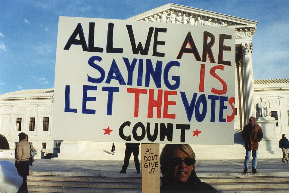 ALL WE ARE SAYING IS LET THE VOTES COUNT protest sign at Presidential Election 2000 Protest at the US Supreme Court on Maryland Avenue between Maryland Avenue and East Capitol Street, NE, Washington DC on Sunday, 3 December 2000 by Elvert Barnes Protest Photography
ELECTION 2000 BUSH VS. GORE SUPREM