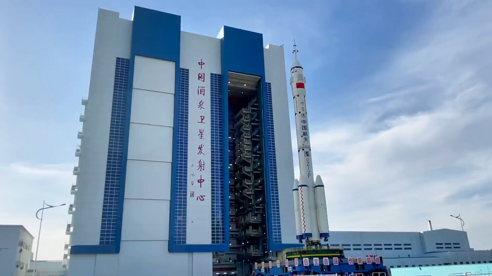 Long March 2F Y12 rocket being rolled out from Launch Vehicle Vertical Assembly Building in Jiuquan Satellite Launch Center