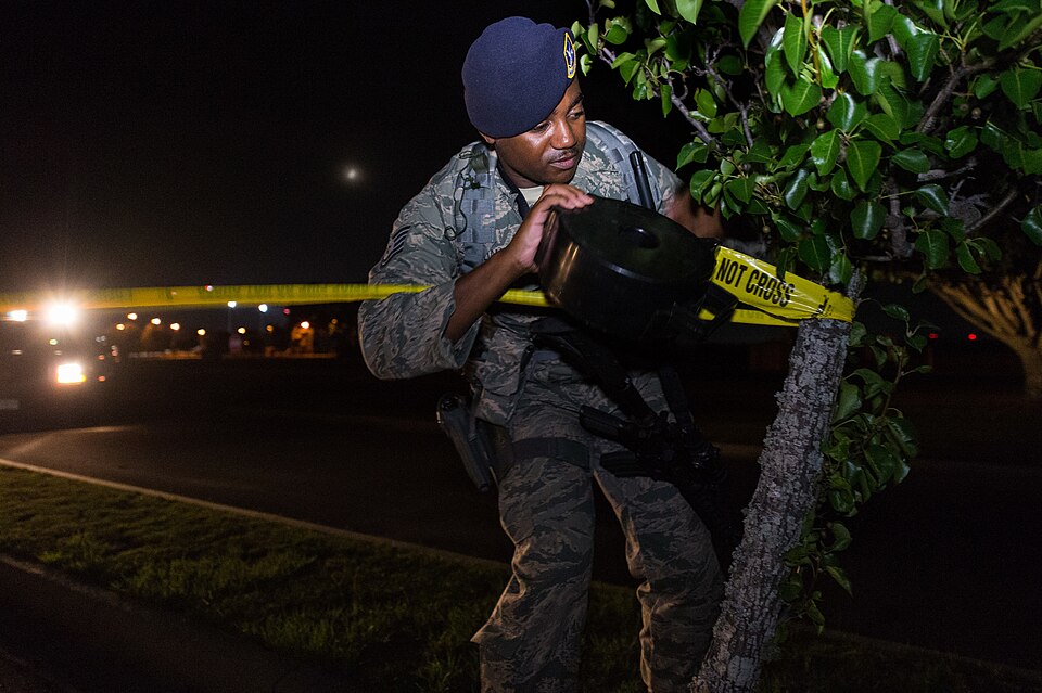 U.S. Air Force Tech. Sgt. Jason Williams, 116th Security Forces Squadron, Georgia Air National Guard, installs crime scene barrier tape around a simulated crime scene during a training exercise at Joint Base Savannah, Ga., June 24, 2015. The JSTARS cops from the Georgia Air National Guard’s 116th Ai