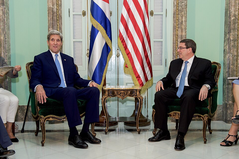 U.S. Secretary of State John Kerry chats with Cuban Foreign Minister Bruno Rodríguez before their bilateral meeting at the Cuban Ministry of Foreign Affairs during the Secretary's historic visit to Havana, Cuba, on August 14, 2015. [State Department photo/ Public Domain]