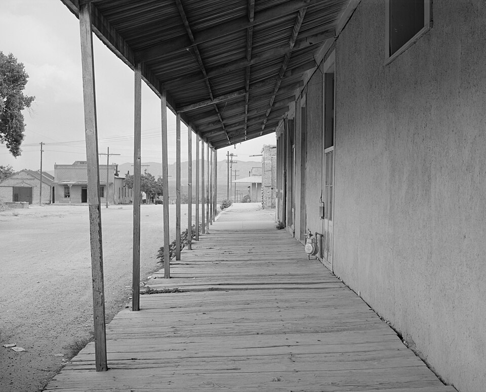 Covered board sidewalk in Tombstone, Arizona. Safety negative, 3 1/4 x 4 1/4 inches or smaller. Farm Security Administration photograph from the Office of War Information Photograph Collection. This is looking north on 5th Street between Allen Street and Fremont Street, standing on the east side of 