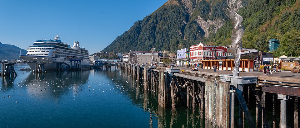 Oceania cruise ship, REGATTA - IMO 9156474, at the dock that runs the length of the harbor in Juneau, Alaska USA. 
Note: There are ten 20-foot-high, stainless steel sculptures mounted on the mooring dolphins the cruise ships tie up to. They are called ‘Aquileans’ by the sculptor, Cliff Garten.