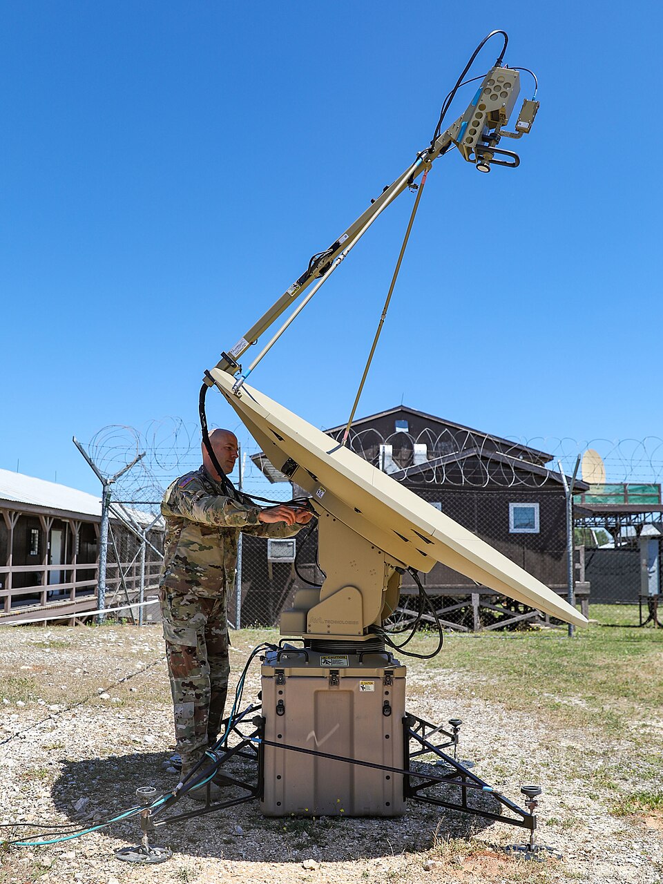 CAMP BONDSTEEL, Kosovo – U.S. Army Sgt. 1st Class Joseph Johnson, a satellite communication systems operator-maintainer assigned to the 116th Infantry Brigade Combat Team, Virginia National Guard, repairs a satellite antenna at Camp Bondsteel, Kosovo, July 18, 2022. Johnson is currently the satellit