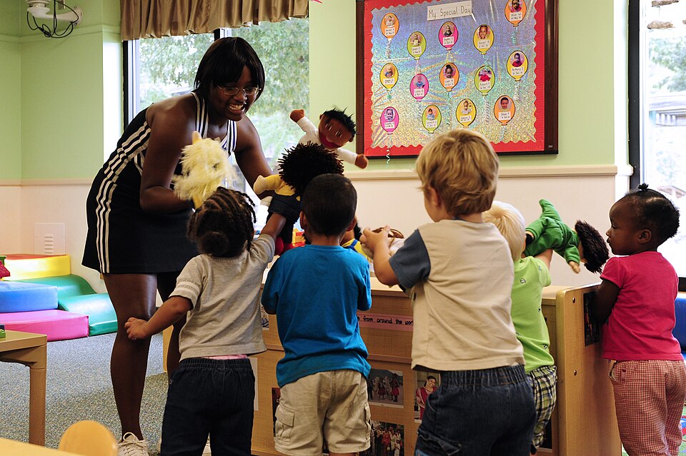 Crestwood High School varsity cheerleading captain MicKayla Ketter plays with toddler class 5-B at Shaw Air Force Base, S.C., Aug. 15, 2012. Ketter and members of her high schoolÕs cheer squad came to teach children about sportsmanship and teamwork.