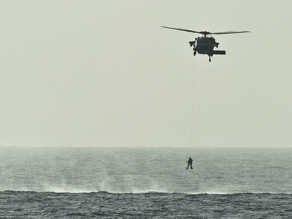 ARABIAN SEA (Feb. 5, 2012) Search and rescue swimmers are hoisted into an MH-60S Sea Hawk helicopter, assigned to Helicopter Sea Combat Squadron (HSC) 23, during a search and rescue training exercise. HSC-23 is embarked aboard the amphibious assault ship USS Makin Island (LHD 8). Makin Island and em