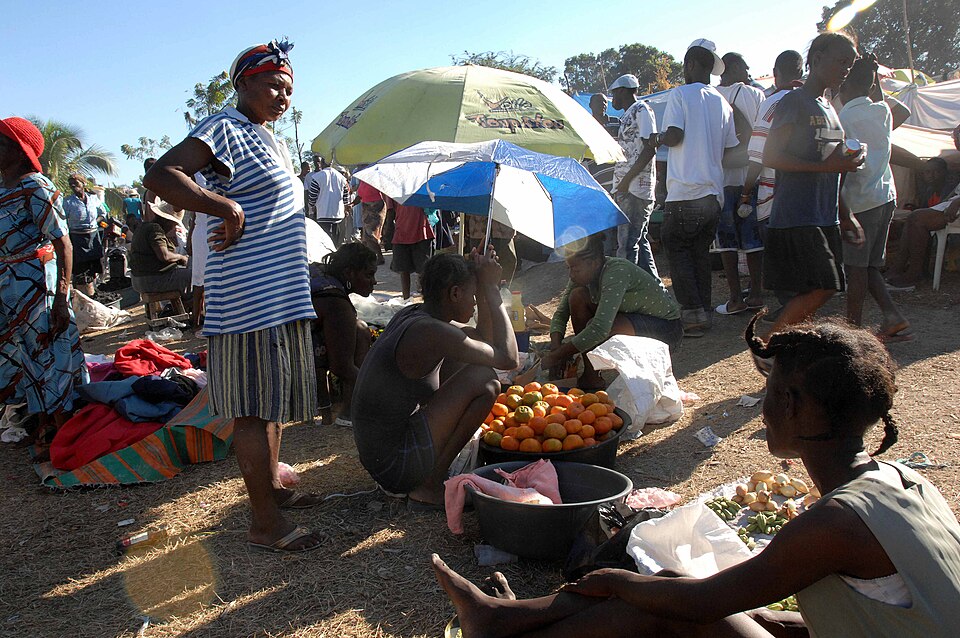 Women open a small market in the earthquake survivor camp in the Del Mas area of Port-au-Prince, Haiti, Jan. 21, 2010. The 82nd Airborne Division's 1st Squadron, 73rd Cavalry Squadron, started distributing food and water here last week.
